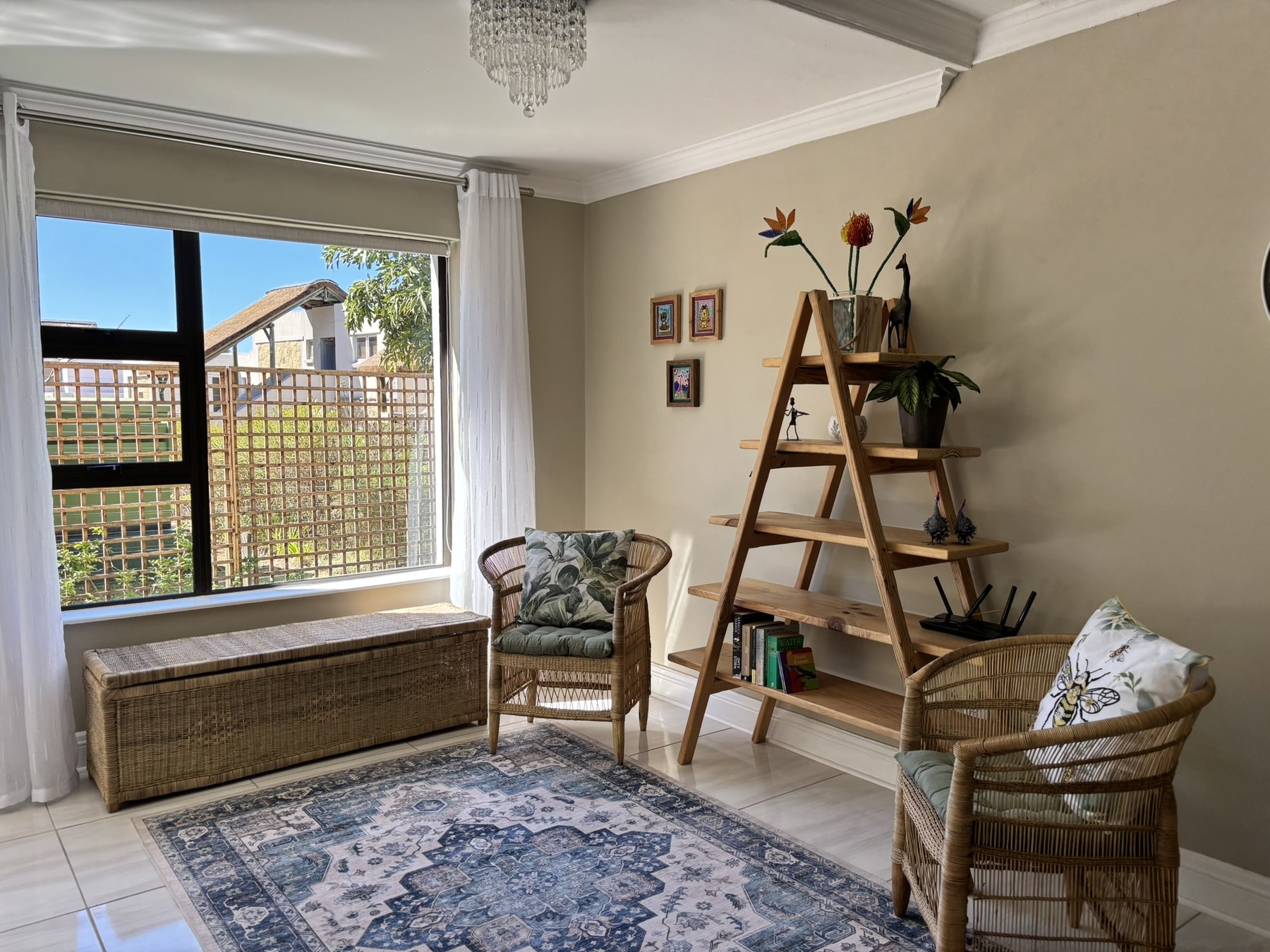 Sunny reading nook with wicker chairs and bookshelf